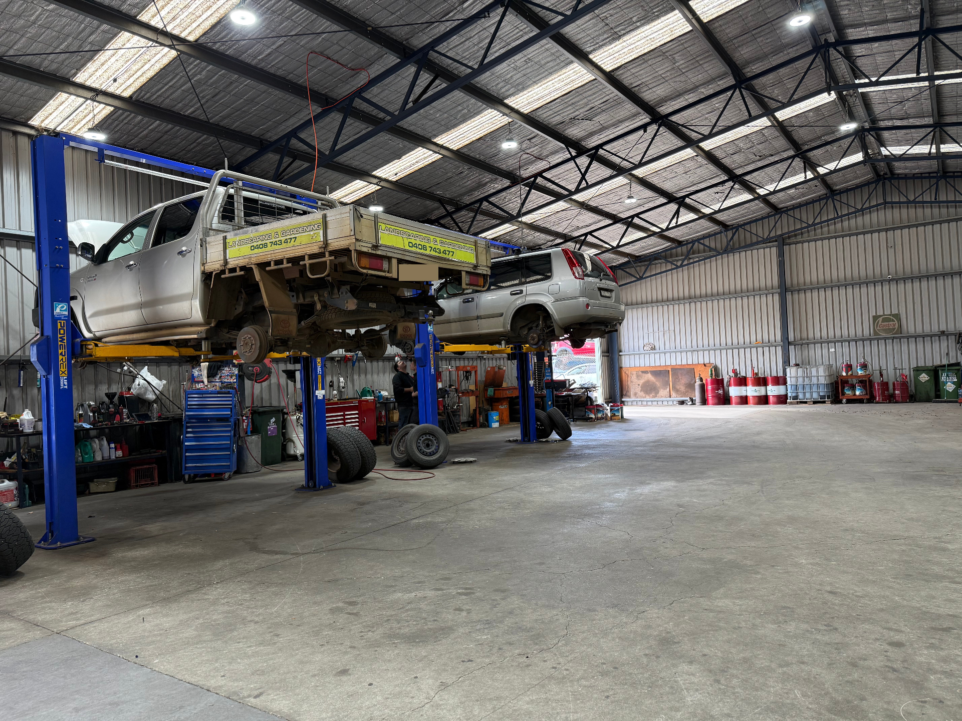 Inside the workshop with vehicles on hoists